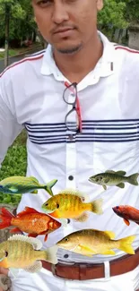 Person with colorful fish print on white shirt.