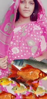 Woman in pink sari with colorful fish.