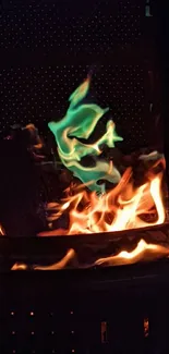 Green and orange flames on a dark background wallpaper.