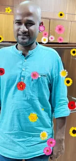 Person wearing a turquoise shirt with vibrant floral design.