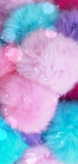 Colorful fluffy pom-poms in pink, blue, and purple on mobile wallpaper.