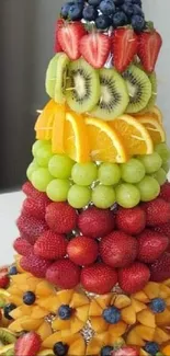 Vibrant layered fruit pyramid display.