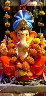 Vibrant Lord Ganesha idol adorned with colorful garlands in a spiritual setting.