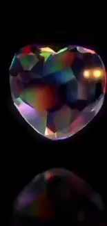 Heart-shaped gemstone with colorful reflections on a dark background.