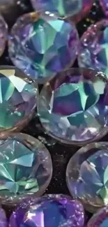 Vibrant iridescent gemstones with a sparkling reflection on black background.