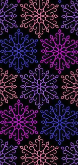 Vibrant snowflake pattern with pink, purple, blue on black background.