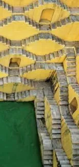 Bright yellow and green stepwell with intricate geometric stair pattern.