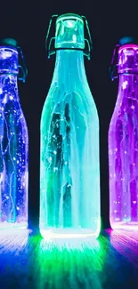 Three glowing bottles in vibrant colors against a dark background.