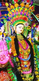 Colorful deity idol with vibrant attire and decorations.