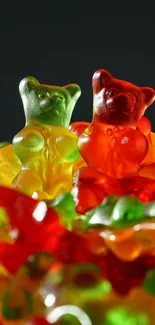 Colorful gummy bears in red and green shades on a dark background.