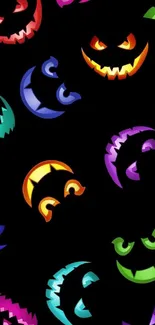 Colorful Halloween pumpkin faces on a black background wallpaper.