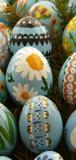 Blue hand-painted eggs with flowers and nature designs.