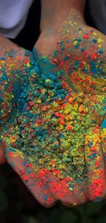 Hands covered in vibrant, colorful powder for a lively wallpaper design.