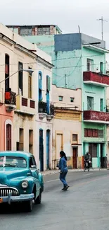 Colorful Havana street with vintage car and vibrant buildings.