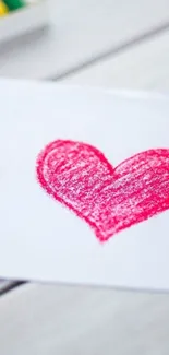 Red crayon heart on white paper background.