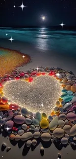 Heart-shaped arrangement of colorful stones on a nighttime beach, glowing under stars.