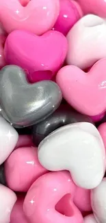 Mobile wallpaper with pink, gray, and white heart-shaped beads.