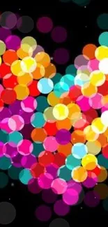 Colorful heart bokeh with vivid circles on dark background.