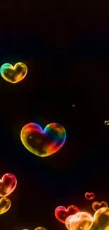 Colorful heart-shaped bubbles on dark background, vibrant and lively.