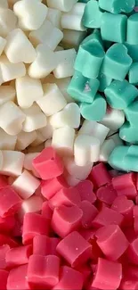 Pastel heart-shaped candies in turquoise, white, and pink hues.