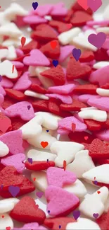 Colorful heart-shaped candy sprinkles scattered on a light background.