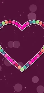 Colorful heart gem design on purple background wallpaper.