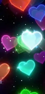 Glowing colorful hearts on black starry background.