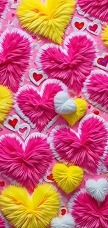 Vibrant pink, yellow, and white heart pattern on mobile wallpaper.