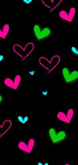 Bright neon hearts on a black background wallpaper.