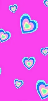 Pink background with colorful heart pattern wallpaper.