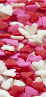 Colorful heart sprinkles wallpaper in red, pink, and white hues.