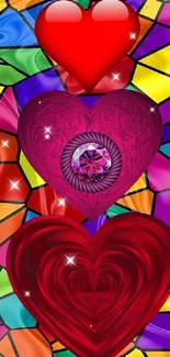 Three vibrant hearts on stained glass background.