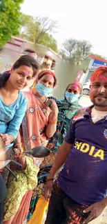 Group of people celebrating Holi with vibrant colors.