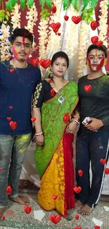 Joyful trio enjoying a colorful Holi celebration with traditional attire.