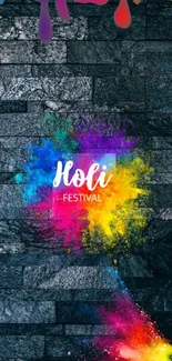 Colorful Holi festival wallpaper on dark stone background