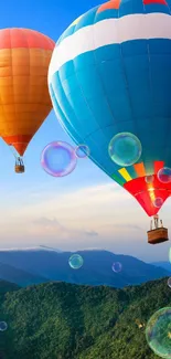 Colorful hot air balloons over green mountains at sunrise.