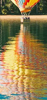 Hot air balloon reflecting on a serene lake with vibrant colors.