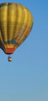 Colorful hot air balloon against a clear blue sky.