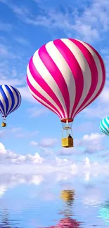 Colorful hot air balloons float in a blue sky over water reflection.