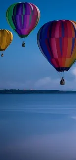 Colorful hot air balloons float over a calm blue sky.