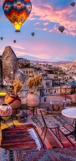 Cappadocia rooftop with hot air balloons in a colorful sunset sky.