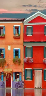 Colorful houses reflecting in calm water, vibrant wallpaper.