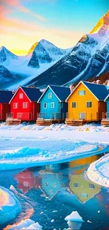 Colorful houses with mountain backdrop and reflecting water.