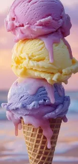 Triple scoop ice cream cone at beach sunset.