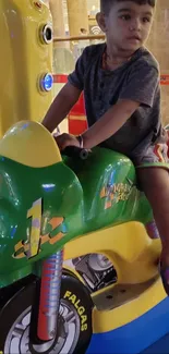 Child enjoying a colorful ride at an indoor arcade.