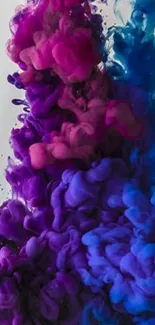 Vibrant ink colors blending in fluid art wallpaper with purple and blue hues.