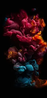 Colorful ink swirl with vibrant pink, orange, and blue splashes on black background.