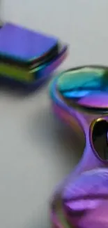 Iridescent fidget spinner with vibrant, colorful design.