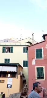 Colorful Italian street view with vibrant houses and lively atmosphere.