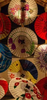 Colorful Japanese umbrellas on wooden display.